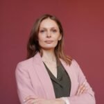 Elegant businesswoman with arms crossed in studio portrait, showcasing leadership and confidence suit, vest, men's match, Testimonial .